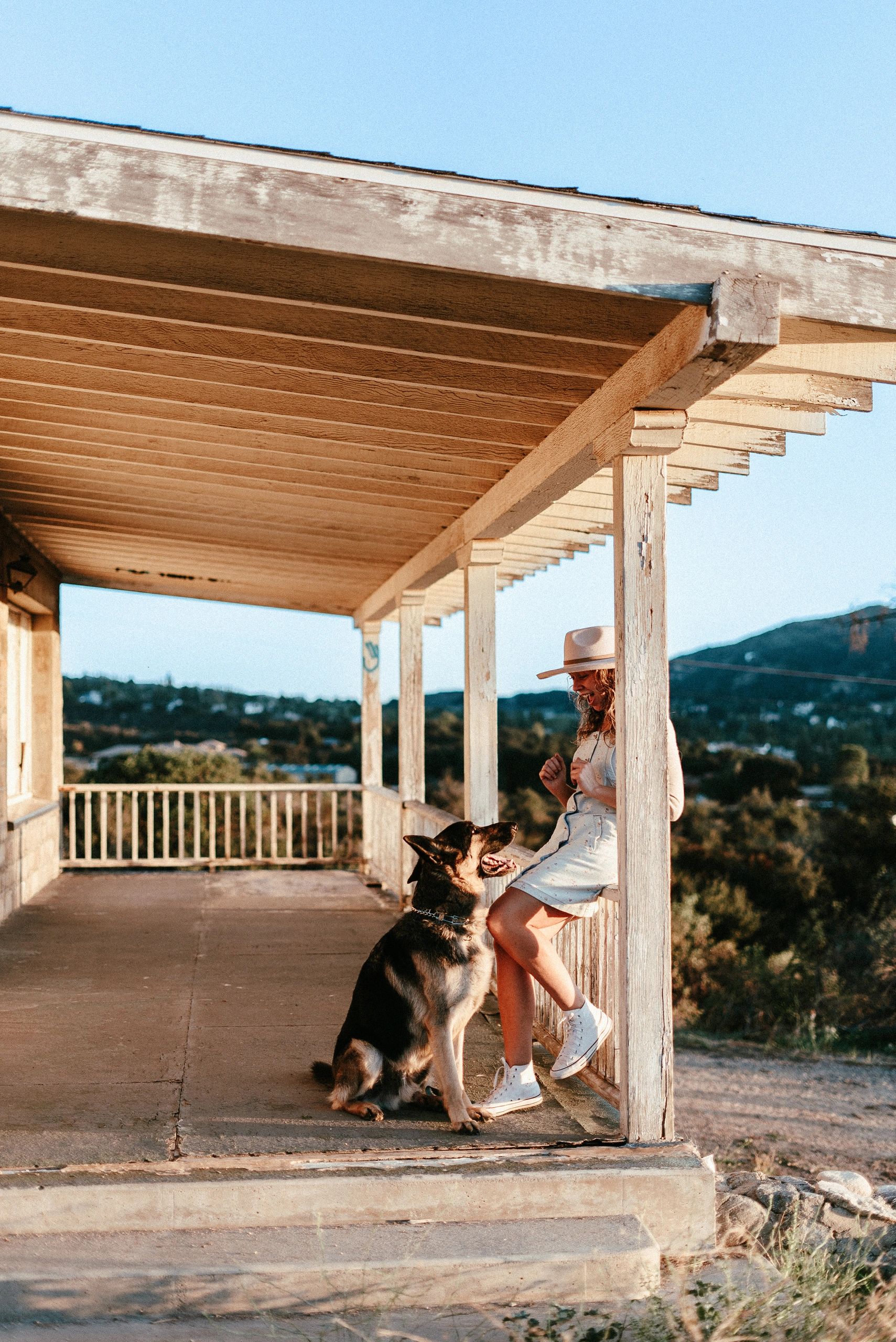 Chantel with German Shepherd on the porch of her Calimesa training home